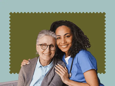 Two women, a caregiver and a healthcare professional, smiling together.