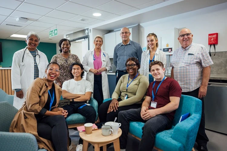 Healthcare team and caregivers at a support meeting in a healthcare facility.