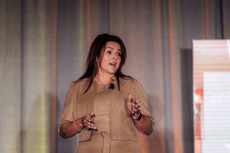 Woman speaking at a conference about care at home services.