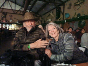 Older man and woman sharing a joyful moment at Lighthouse of Hope event.